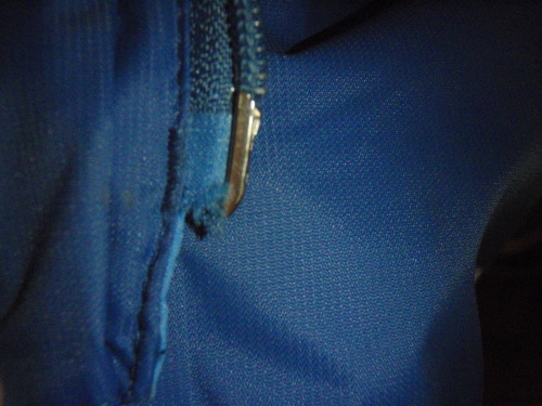 Wear on the side of the zipper from sticking in the pull.